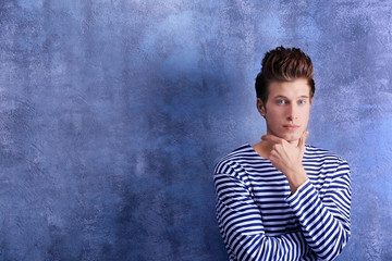 Handsome young man on color background