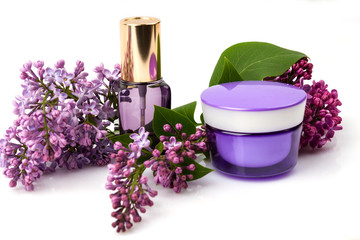 Obraz na płótnie Canvas Cosmetic face care products and lilac flowers isolated on white background. Cream, fluid, serum. 