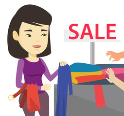 Young woman choosing clothes in shop on sale
