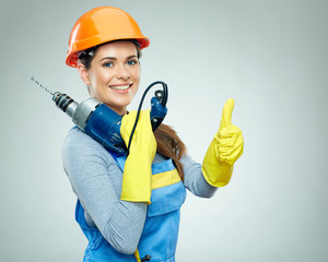 Woman builder with drill tool shows thumb up.