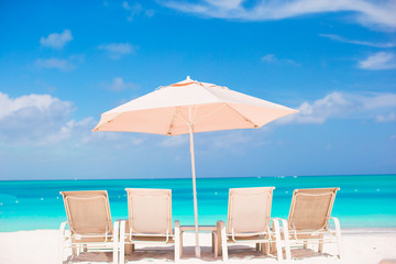 Sunbeds and umbrella at beautiful tropical sand beach