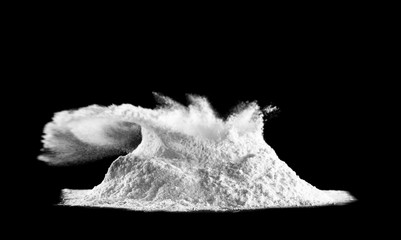 Pile of bursting flour on dark background