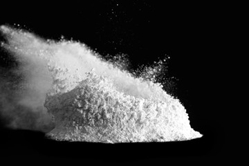 Pile of bursting flour on dark background