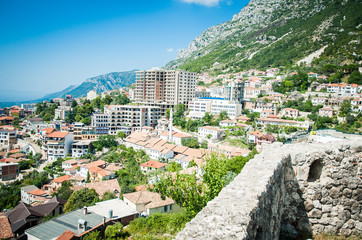 2016, Albania, Kruja. Beautiful view to the city and moutains. Blue sky and green landscape with red roofs of the city - obrazy, fototapety, plakaty
