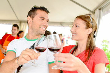 man and woman tossing wine