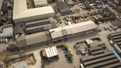 Industrial Estate: Warehouses and Factories; high angled vertical drone reverse - Powered by Adobe