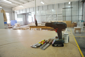 Carpentry tools - screwdriver, pliers, calipers, chisel against the background of the carpentry workshop