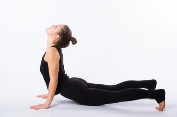 healthy yoga stretching woman does a downward facing dog. This is part of a series of various yoga poses by this model, isolated on white