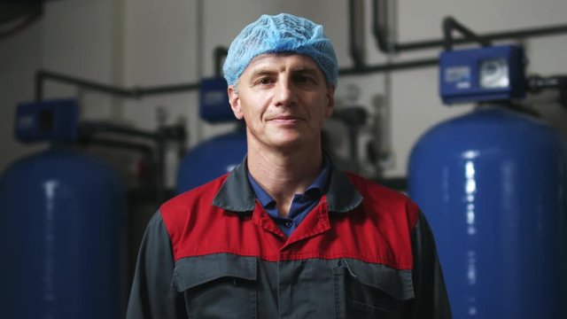 Factory worker portrait. Industrial man looking at camera. Close up of industry worker portrait. Industry man portrait. Factory engineer face. Technical worker portrait. Industrial worker in uniform