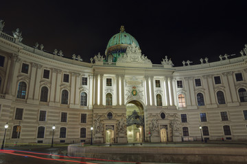 Fototapeta na wymiar Building of the St. Michael wing (Michaelertrakt) of the Hofburg Palace with night illumination. Vienna, Austria