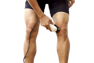 A professional cyclist shaving his legs using hair clipper for improving aerodynamics isolated