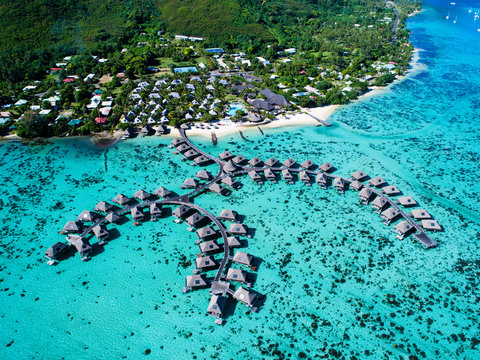 Beach huts in a row on sea, aerial view, Mo'orea, South Pacific