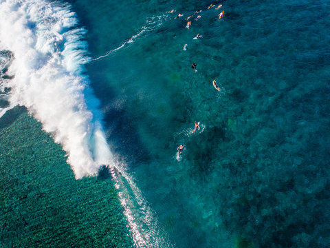 Aerial of surfers in sea, Teahupoo, Tahiti, South Pacific