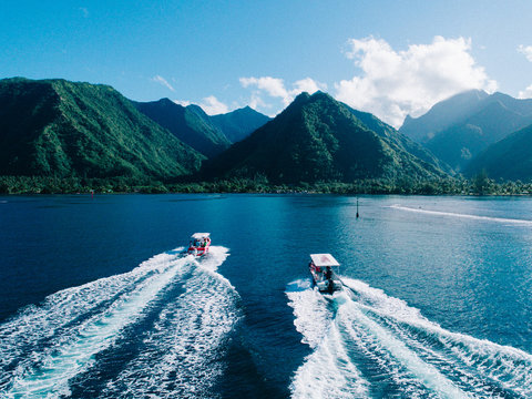 Aerial view of boats on water, heading towards island, Teahupoo, Tahiti, South Pacific