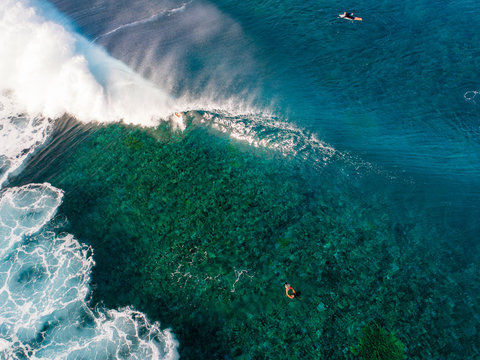 Aerial view of surfers surfing in ocean