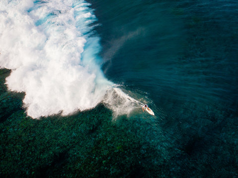 Aerial view of surfer riding wave, Teahupoo, Tahiti