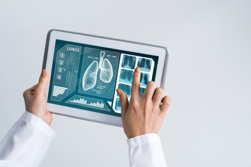 Close of female doctor hands working with tablet pc computer