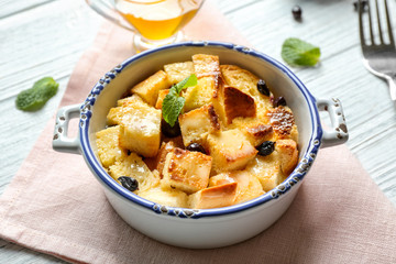 Bowl with delicious bread pudding on napkin