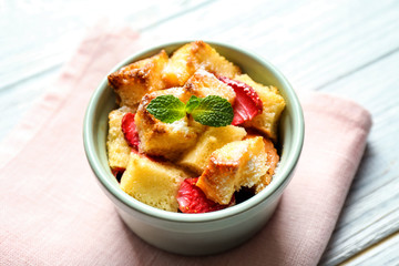 Delicious bread pudding with strawberry and mint on napkin