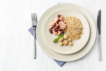 Tasty dish with chicken, rice, beans and mushrooms on plate