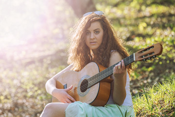 Girl with red hair playing guitar