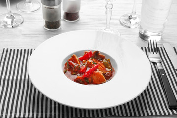 Plate with tasty chicken cacciatore on table