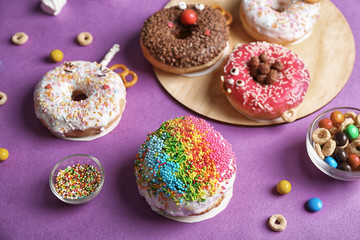Funny decorated donuts on table