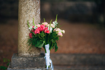 Fototapeta na wymiar Wedding bouquet on a stone background. Wedding in Montenegro