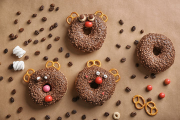Funny decorated donuts on table