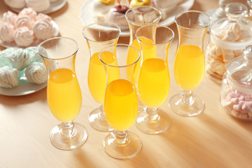Glasses with juice and sweets on table prepared for party