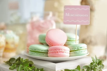Foto op Canvas Plate with macarons on wooden stand © Africa Studio