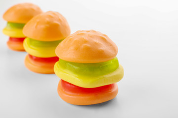 Tasty jelly candies on white background