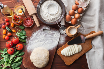 Step-by-step boss makes a pizza margarita. Dough and pizza ingredients