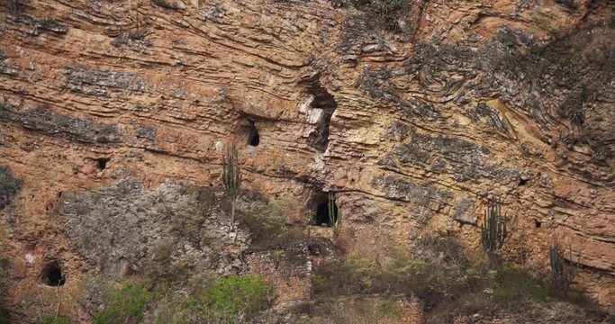 Grave in caves in a rock face in Peru near Kuelap. Chachapoya culture in South America.