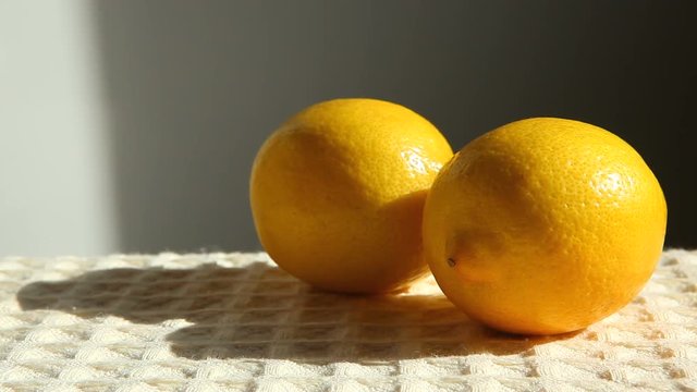 Hand picks up lemon
