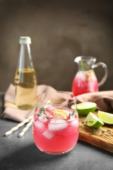 Glass with delicious wine spritzer on grey table