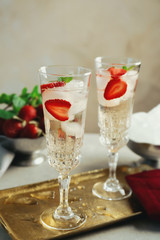 Glasses with delicious wine spritzer on golden tray
