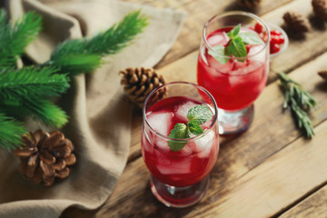 Glasses of delicious wine spritzer on wooden table