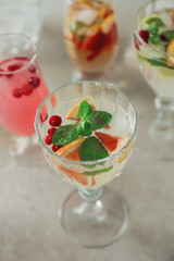 Glass of delicious wine spritzer on grey table
