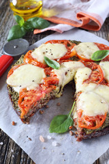 Gluten-free: pizza with mozzarella and pesto on a black rice