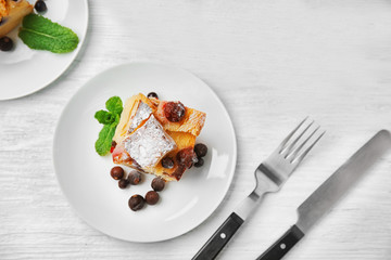 Delicious bread pudding with berries on wooden table