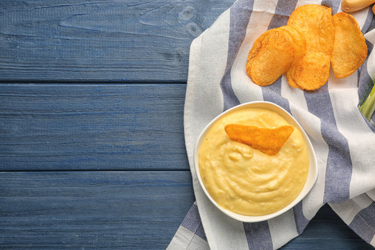 Bowl With Beer Cheese Dip And Nacho On Wooden Background