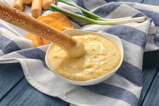 Bowl With Beer Cheese Dip And Bread Stick On Napkin