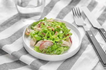 Plate with chicken salad and grapes on table