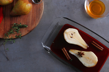 Sliced pear with wine and spices in glass dish