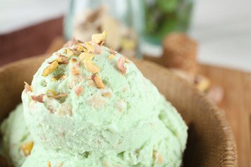 Bowl with delicious pistachio ice cream, close up