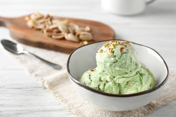 Bowl with delicious pistachio ice cream, close up