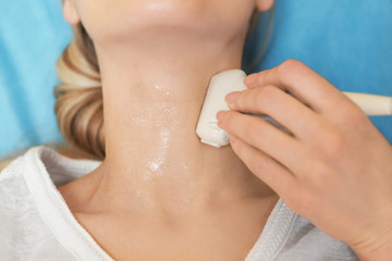Young woman undergoing ultrasound scan in modern clinic
