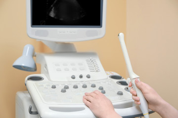 Doctor adjusting ultrasound machine in clinic