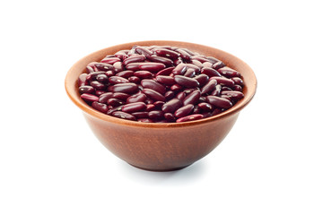 Ceramic bowl of raw red beans on white
